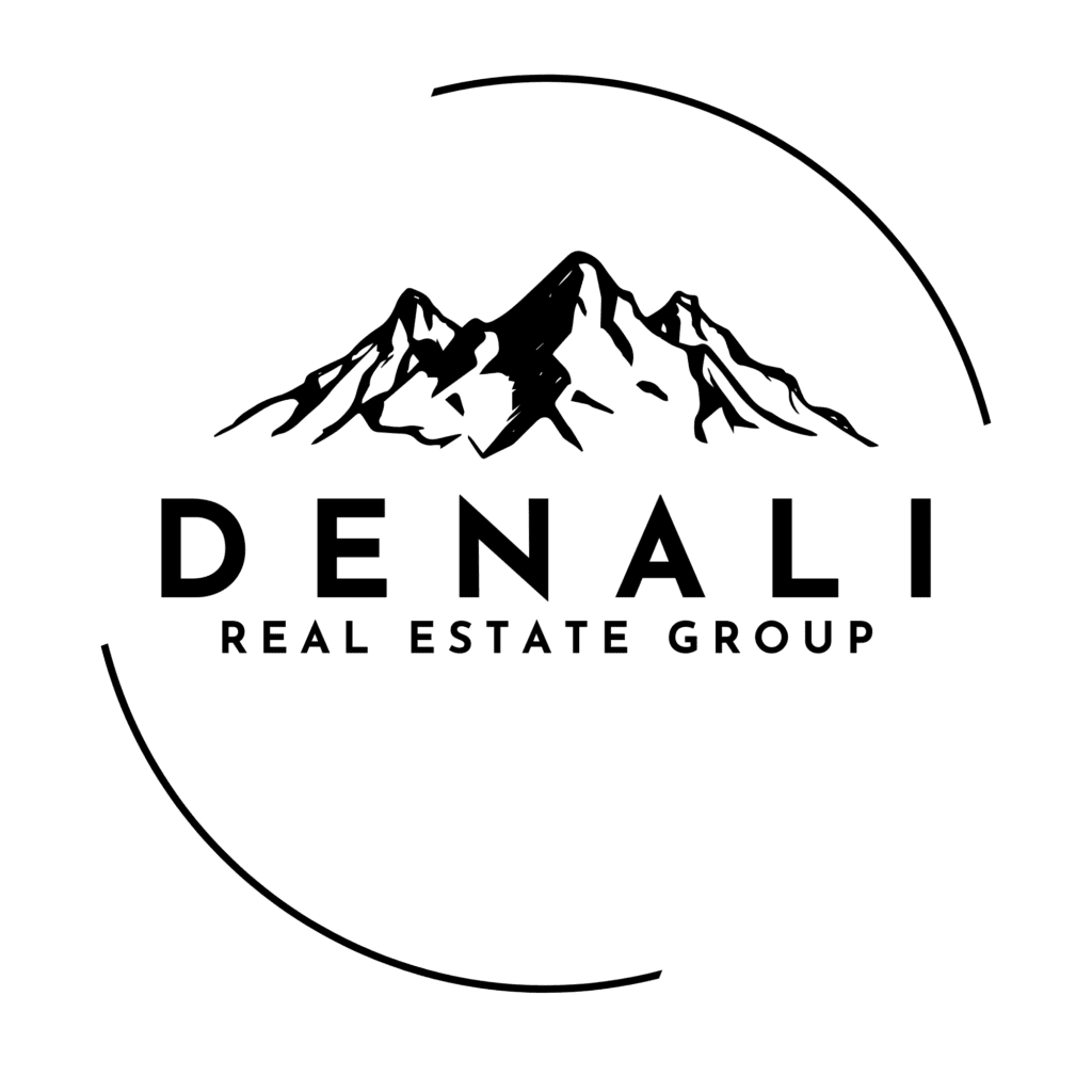 A black and white logo for Denali Real Estate Group with a mountain drawing above the company name and semi circle around it.
